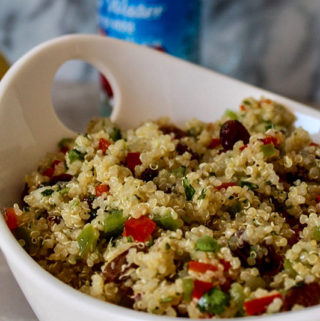 a big bowl filled with a colorful quinoa salad