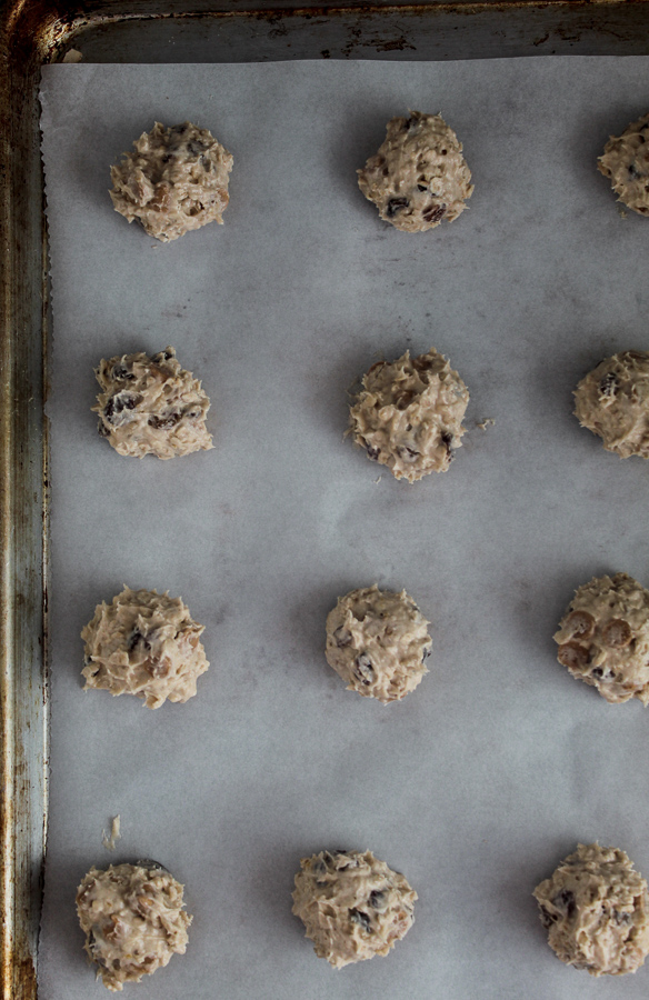 a large baking sheet lined with parchment paper and tablespoon mounds of cookie dough 