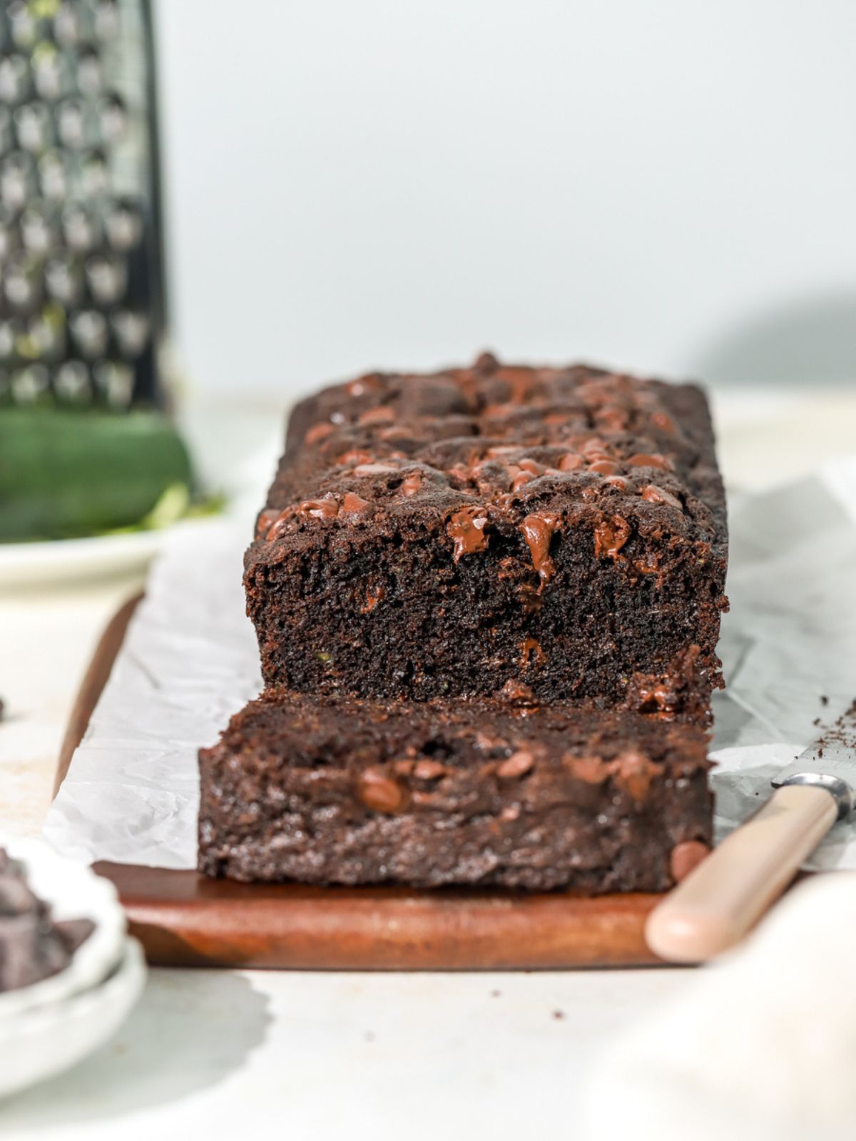 Chocolate zucchini bread being sliced.