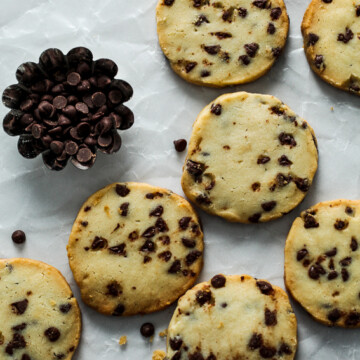 Shortbread cookies with chocolate chips on wax paper.
