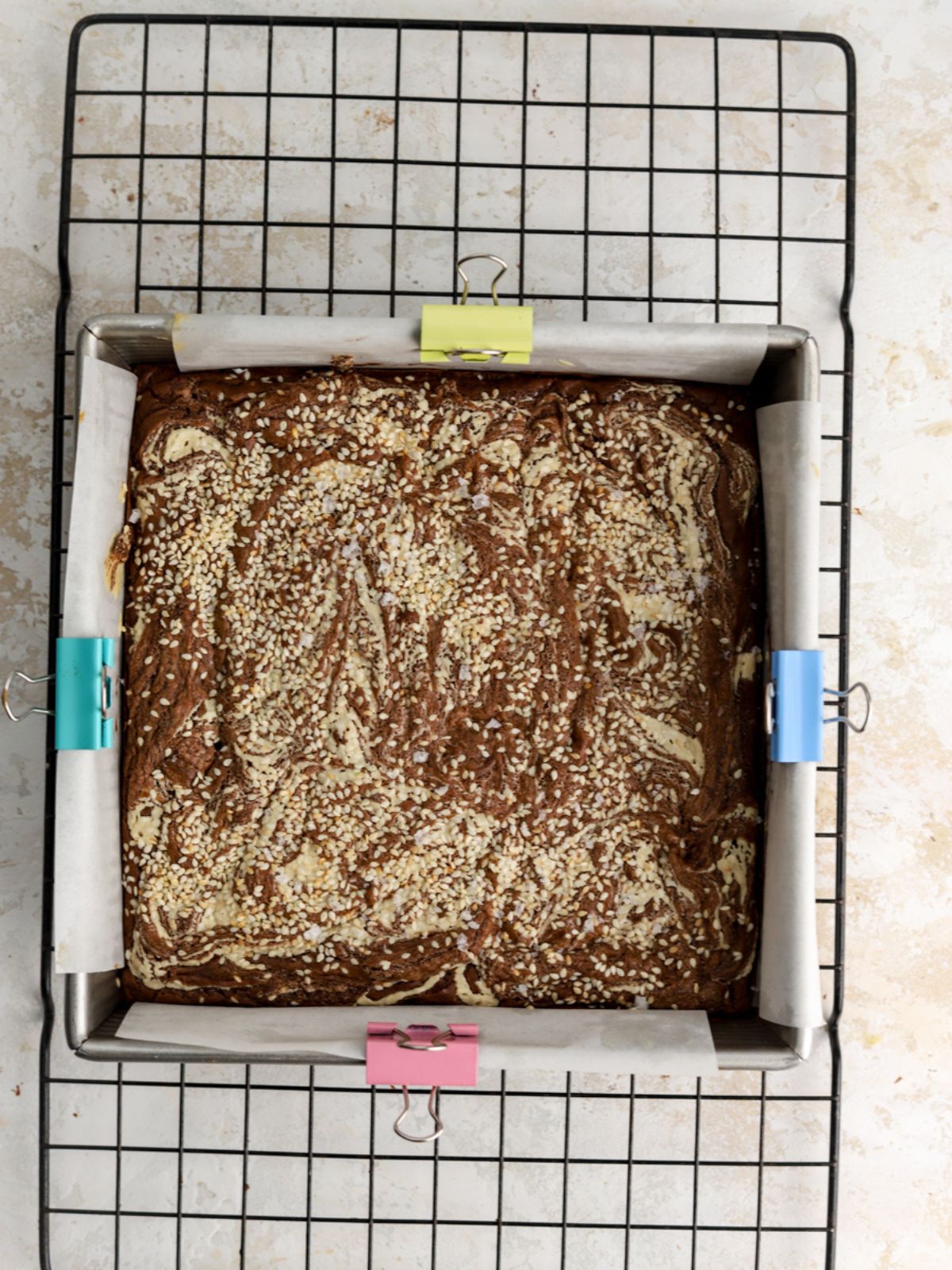 A pan of tahini brownies on a rack. 