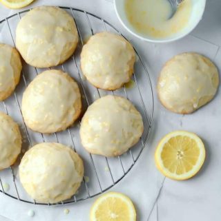 soft lemon cookies with icing on a rack
