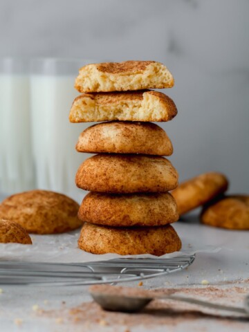 A stack of Snickerdoodles on a baking rack.