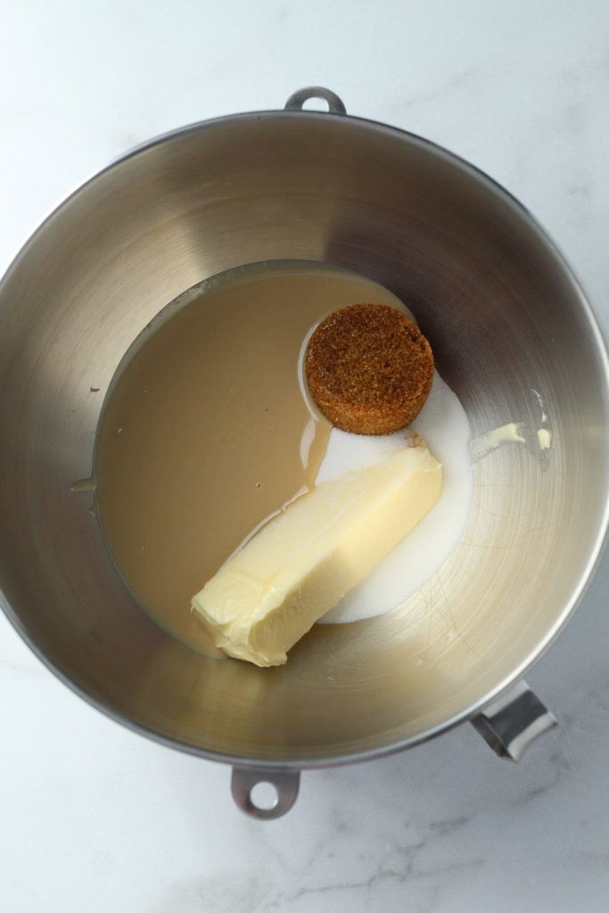 Tahini, brown sugar, granulated sugar and a stick of butter in the bowl of an electric mixer. 