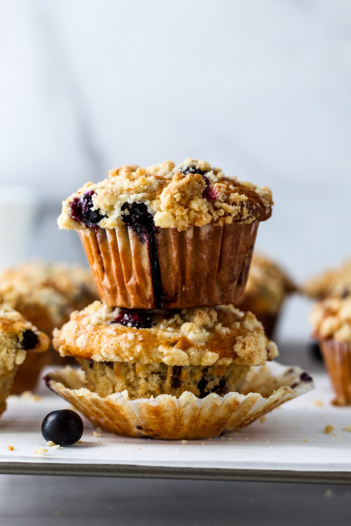 Two delicious freshly baked blueberry muffins stacked on top of each other. 