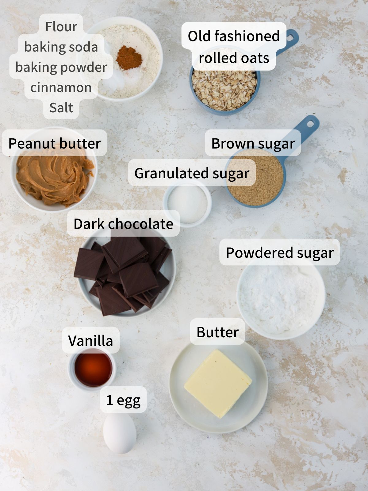 Labeled ingredients needed to make peanut butter sandwich cookies laid out on a table.
