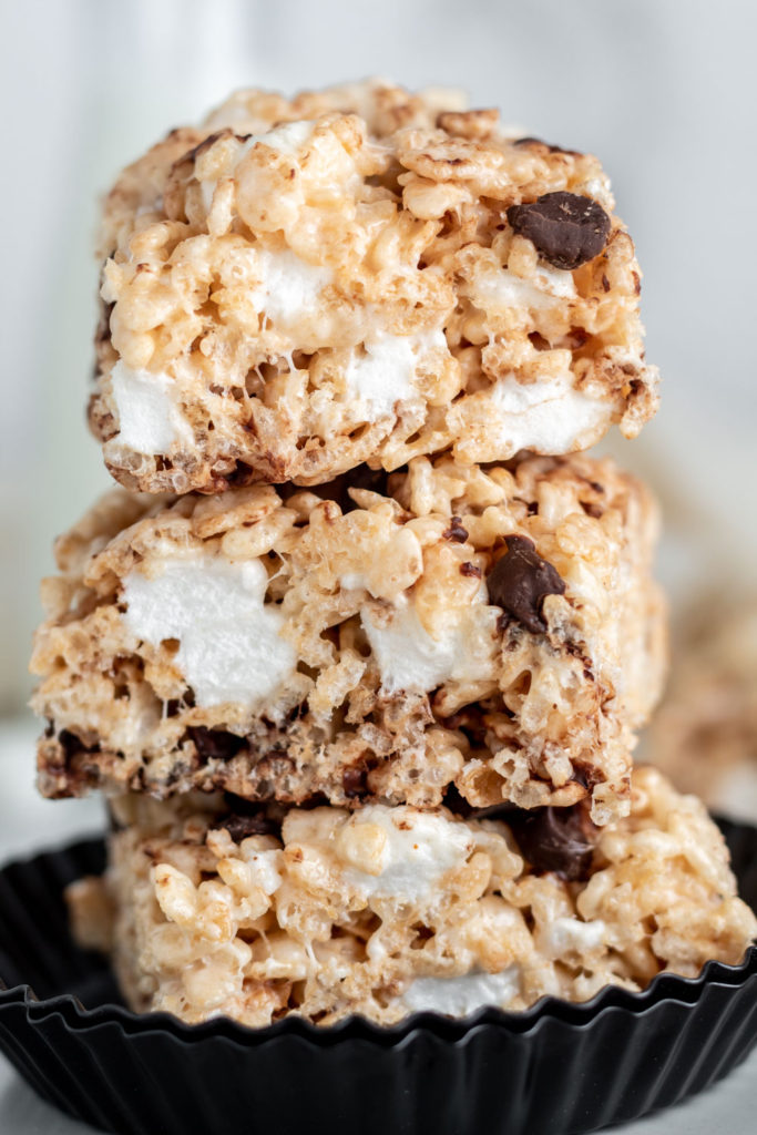 A stack of three Rice Krispie Treat squares with chocolate chips in them.