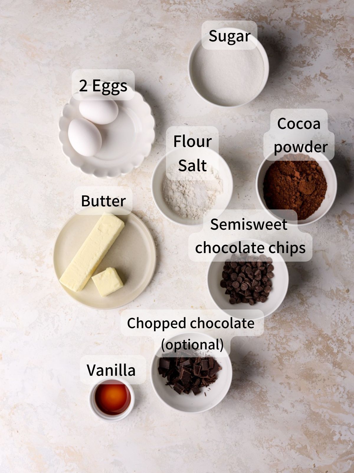 Labeled ingredients needed to make brown butter brownies laid out on a table. 