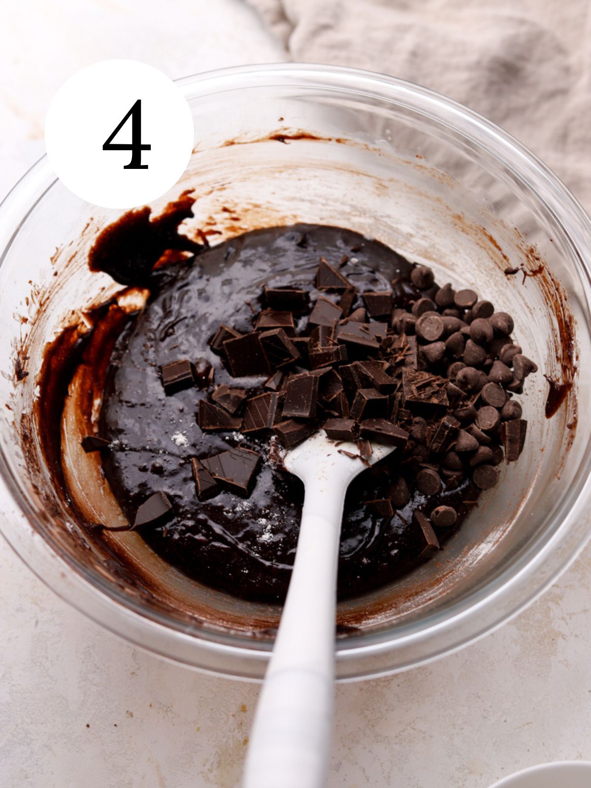Chocolate being stirred into brownie batter. 