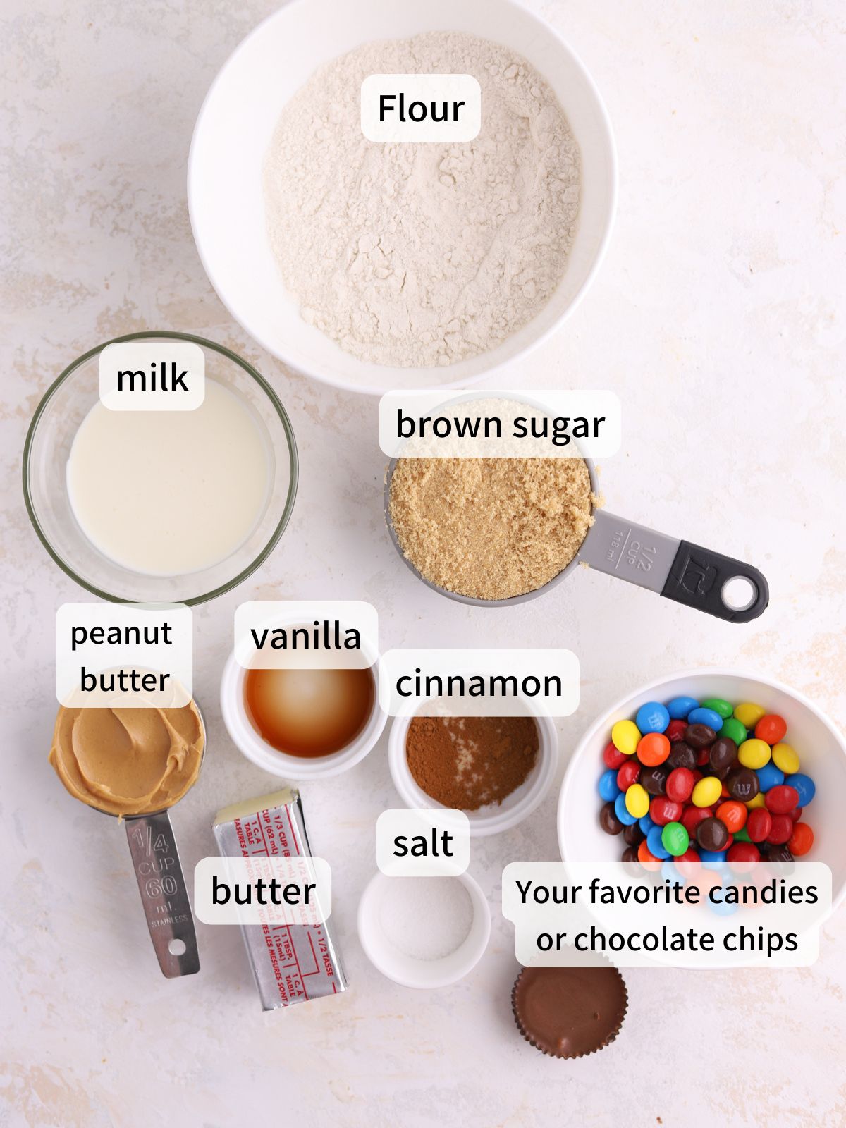 Labeled ingredients needed to make edible peanut butter cookie dough laid out on a table. 