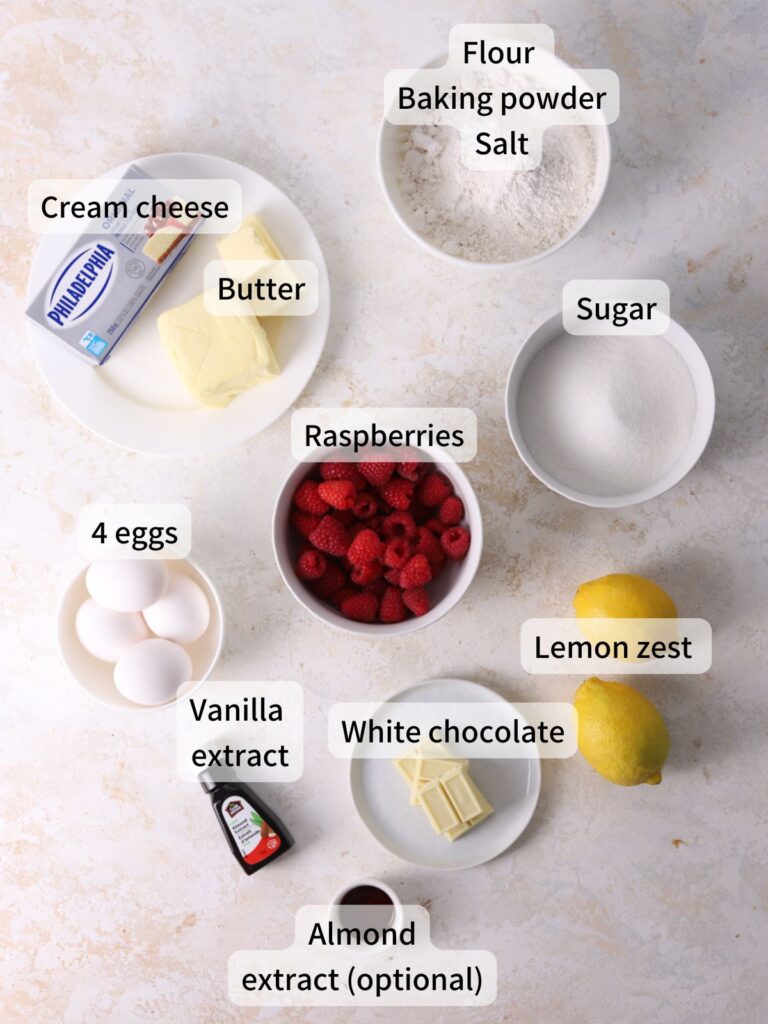 Labeled ingredients needed to make raspberry loaf cake laid out on a table.