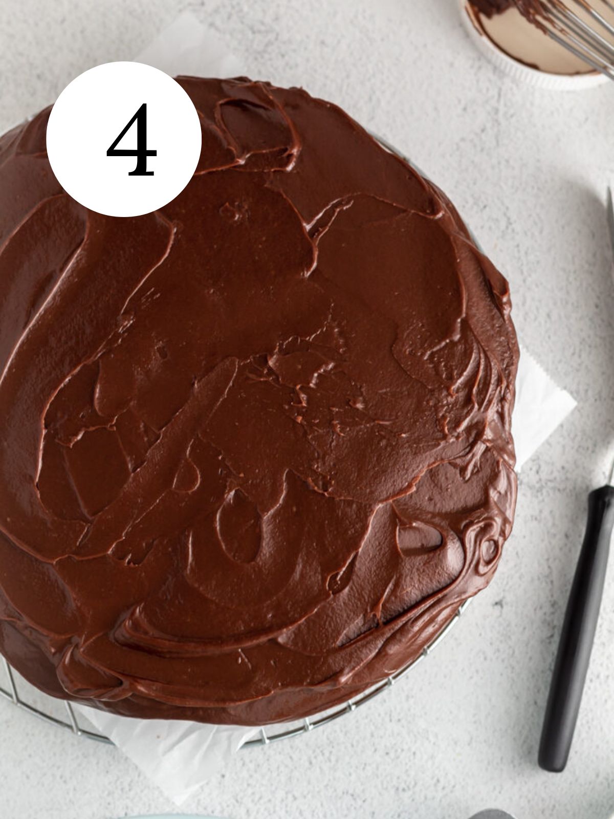 Nutella ganache spread over a cake. 