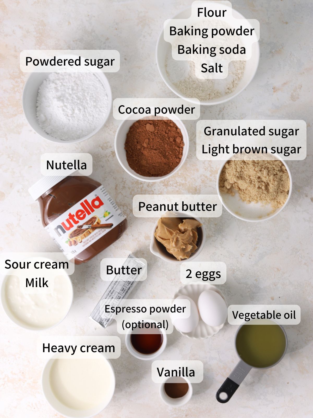 Labeled ingredients needed to make peanut butter nutella cake laid out on a table.