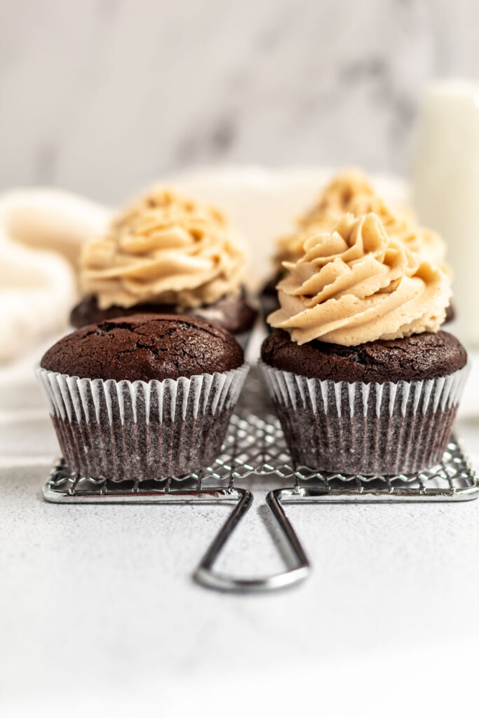 Beautiful and delicious looking chocolate Peanut Butter Cupcakes on a rack. 