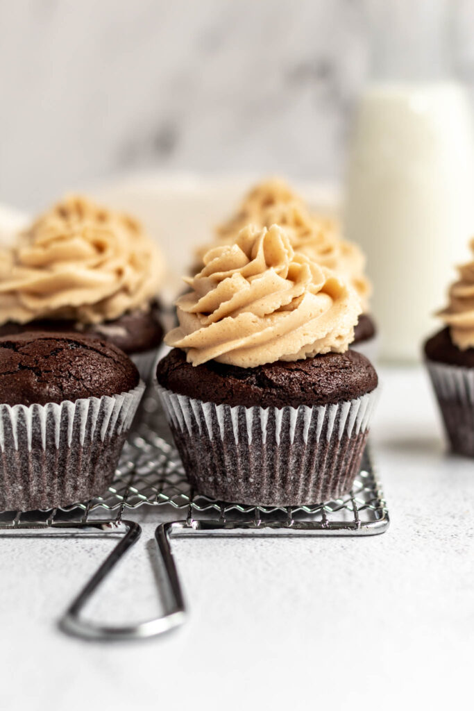 A close up of a delicious chocolate cupcake topped with peanut butter frosting. 