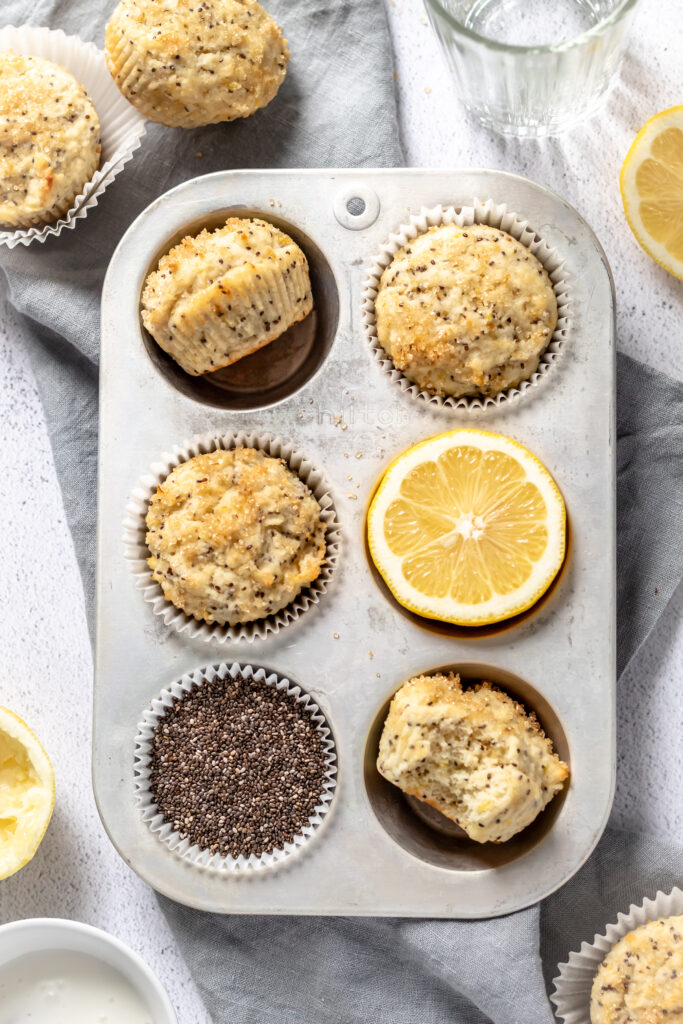 Muffins,  chia seeds, and a lemon on a kitchen linen. 