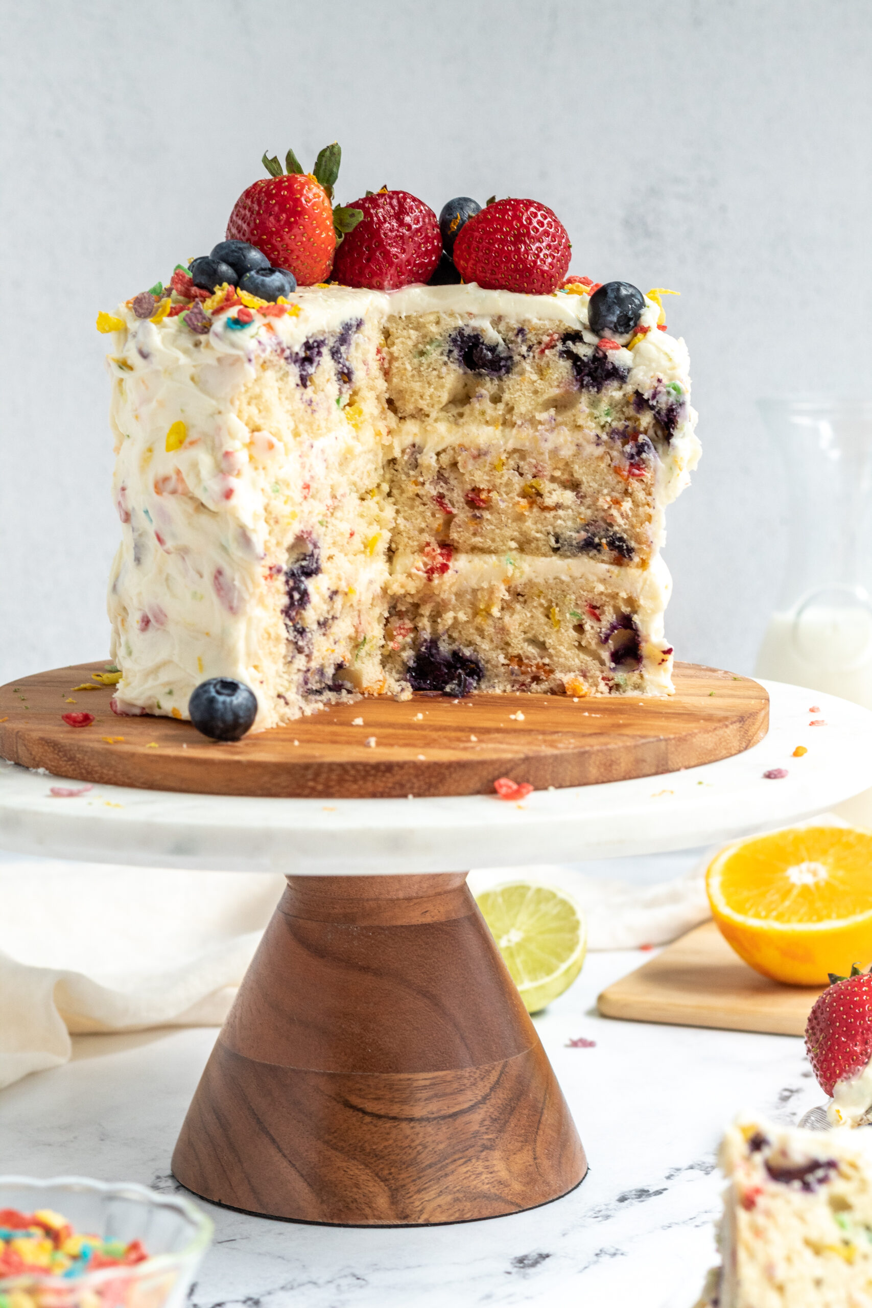 A three layer cake cut in half with fruit baked inside. 