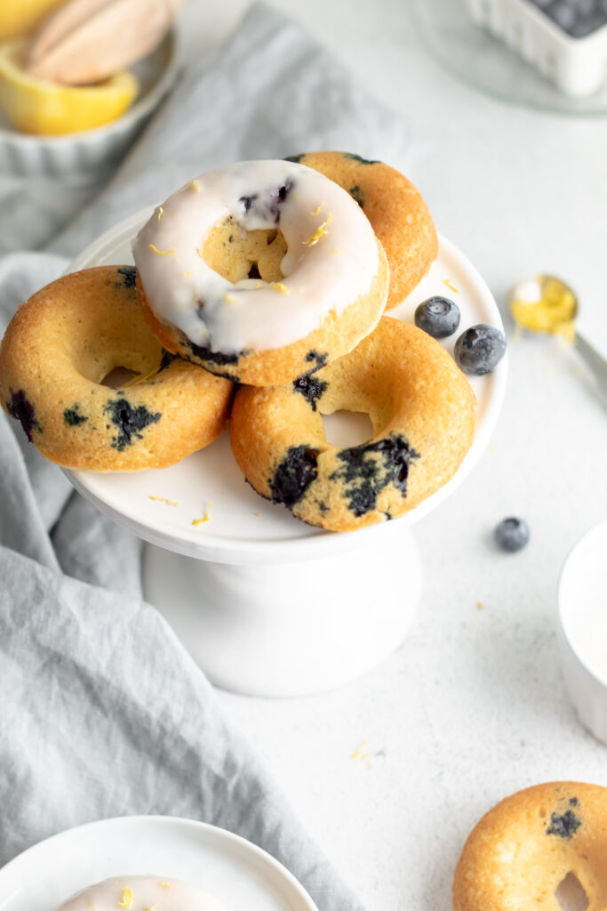 Donuts with blueberries baked inside on a white latter. 