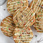 Big cookies with Christmas sprinkles and chocolate chips and white chocolate on top.