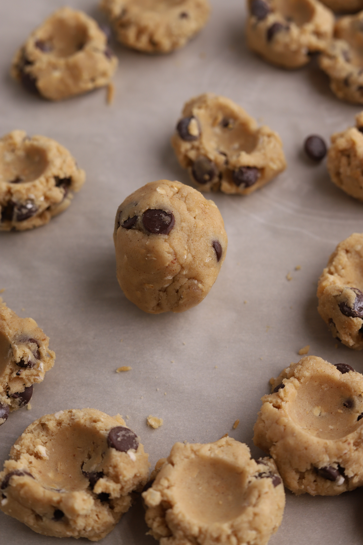 Cookie dough being rolled into balls. 
