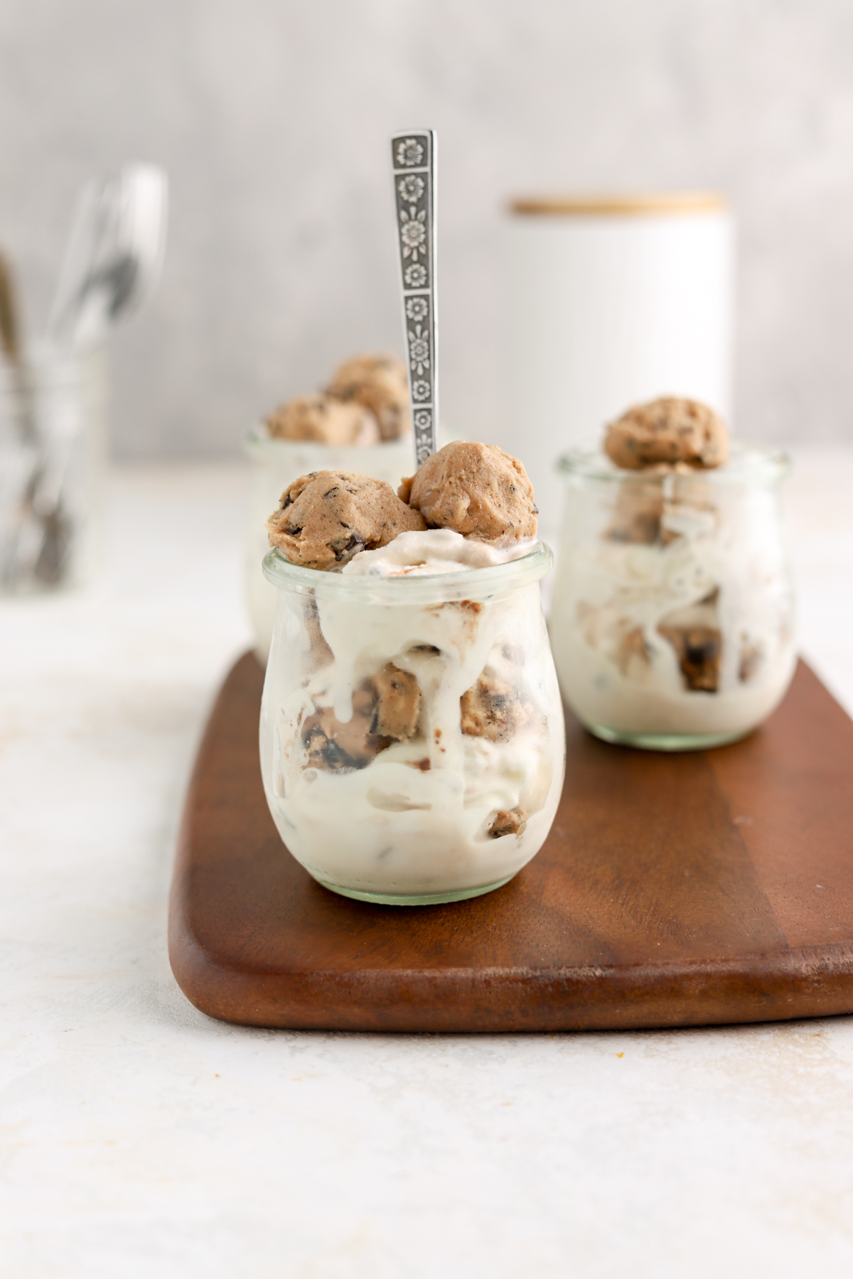 Homemade blizzards filled with cookie dough in glass jars. 