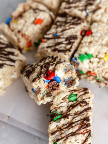 Rice krispie treats with M&Ms and chocolate on top.