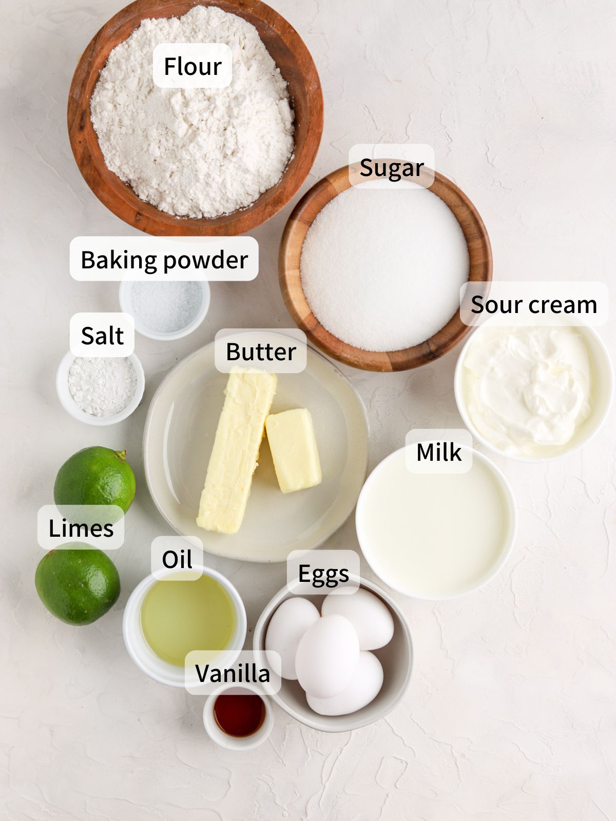 Labeled ingredients needed to make lime cake laid out on a table. 