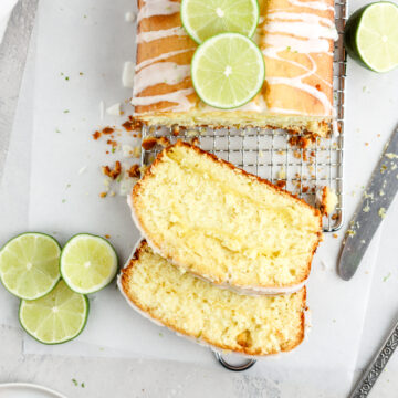 Lime drizzle loaf cake with lime slices on top.
