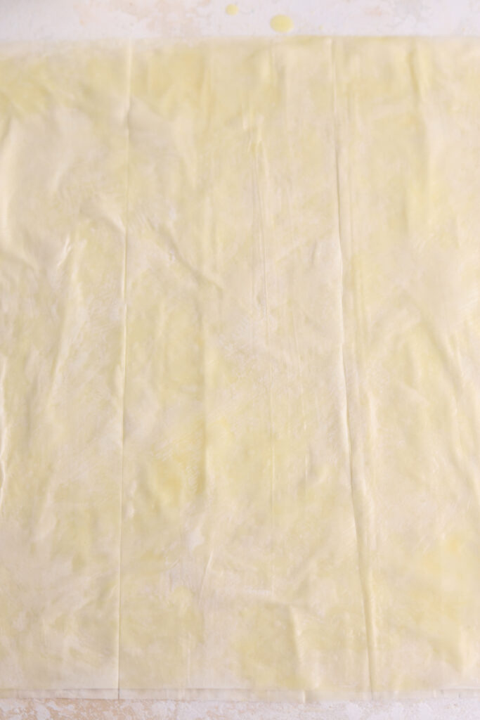 Buttered sheets of phyllo dough. 