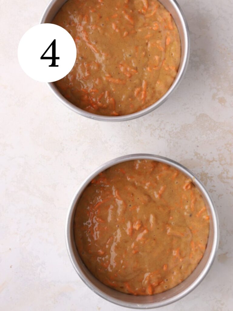 Two six inch round pans with carrot cake batter. 