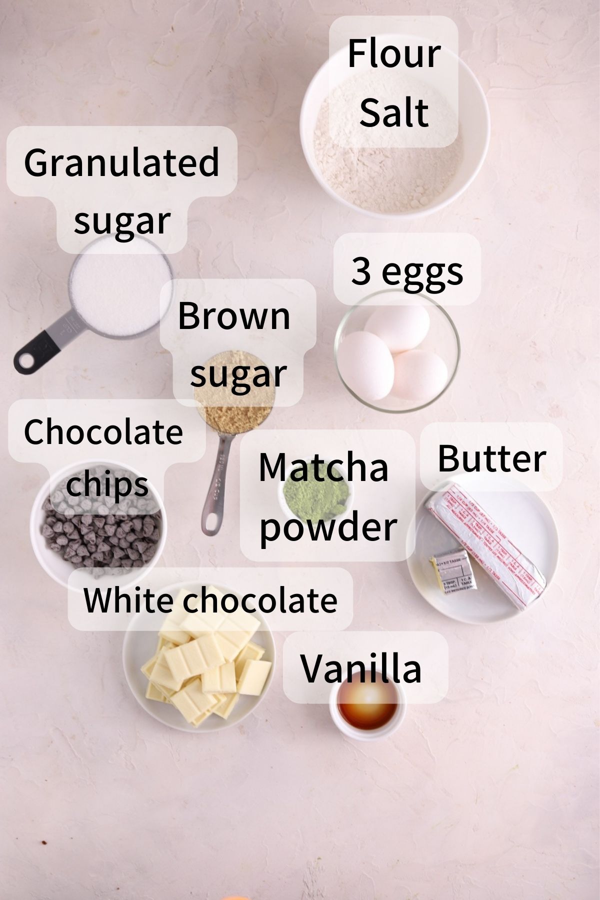 Labeled ingredients needed to make matcha brownies laid out on a table. 