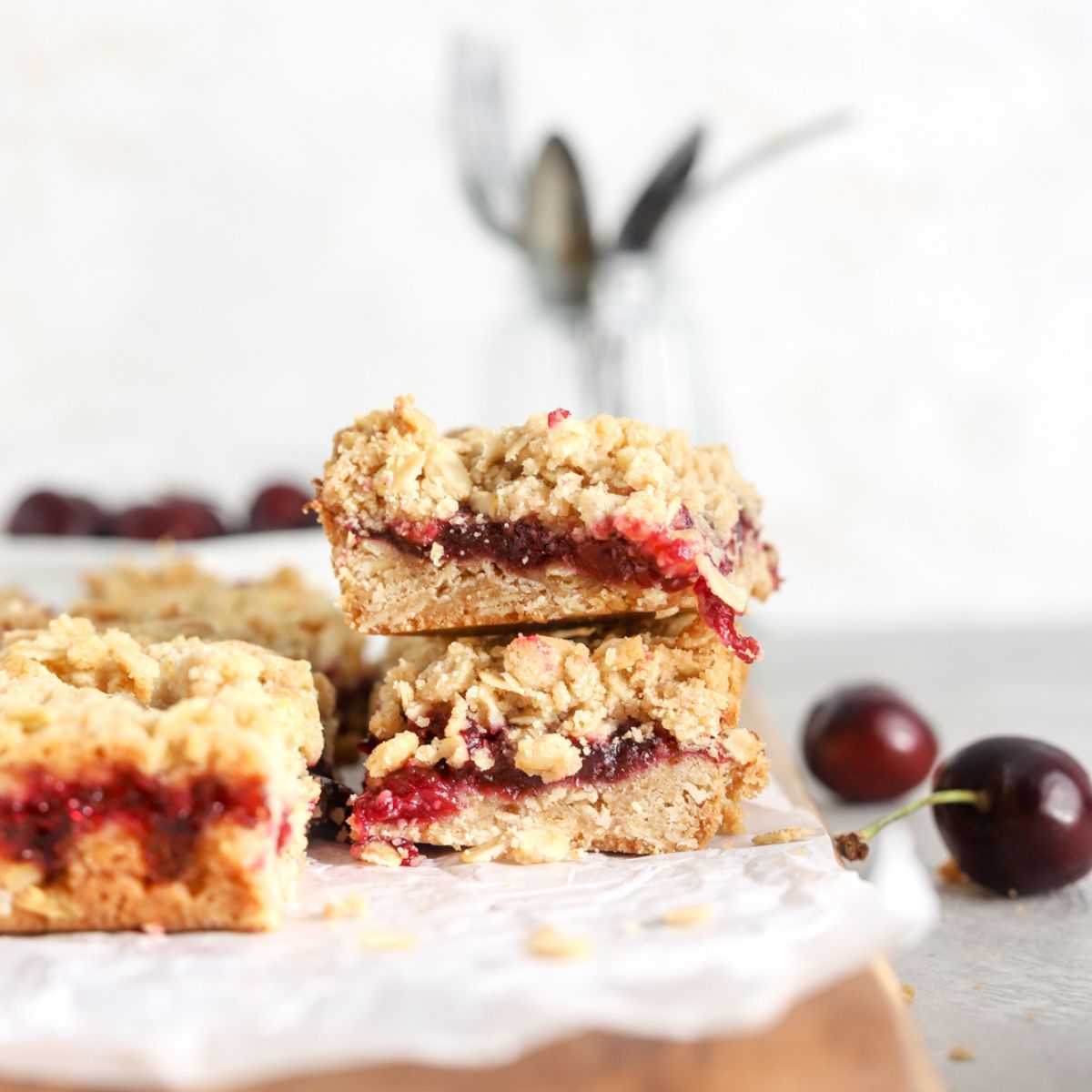 A stack of two cherry squares with cherry filling and crumble topping.