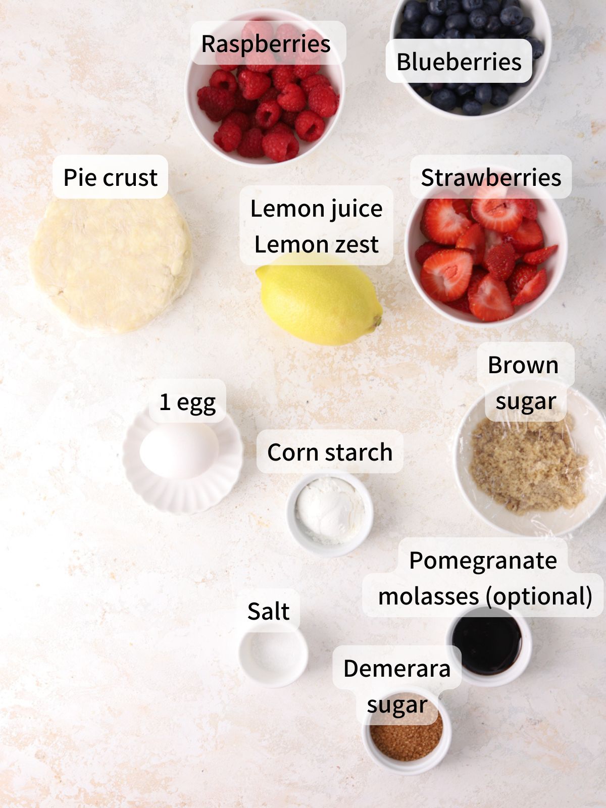 Labeled ingredients for berry galette laid out on a table. 