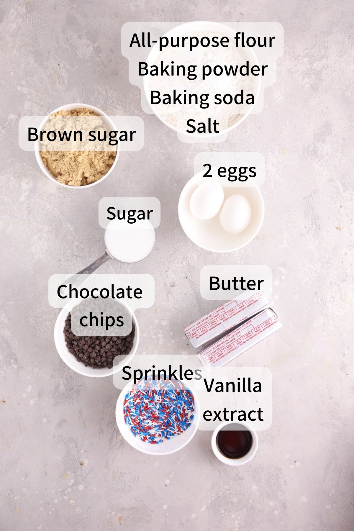 Labeled ingredients needed to make 4th of July cookies laid out on a table.