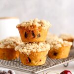 A batch of chocolate cherry muffins on a cooling rack.