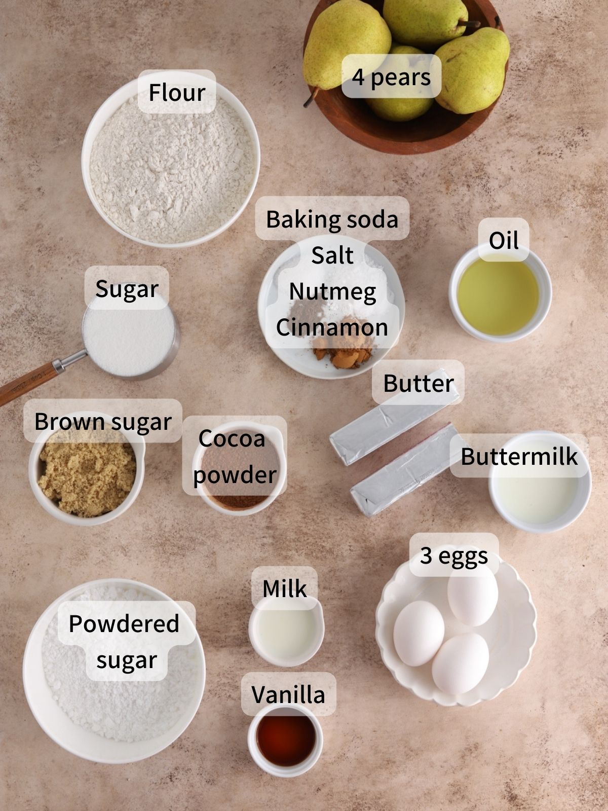 Labeled ingredients needed to make chocolate pear cake laid out on a table. 
