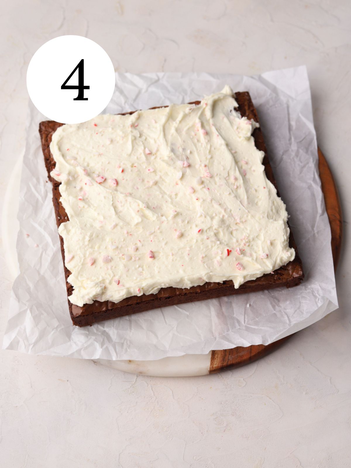 Brownies with frosting and crushed peppermint candy on top.