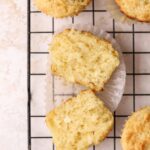 A ricotta muffin cut in half on a wire rack.