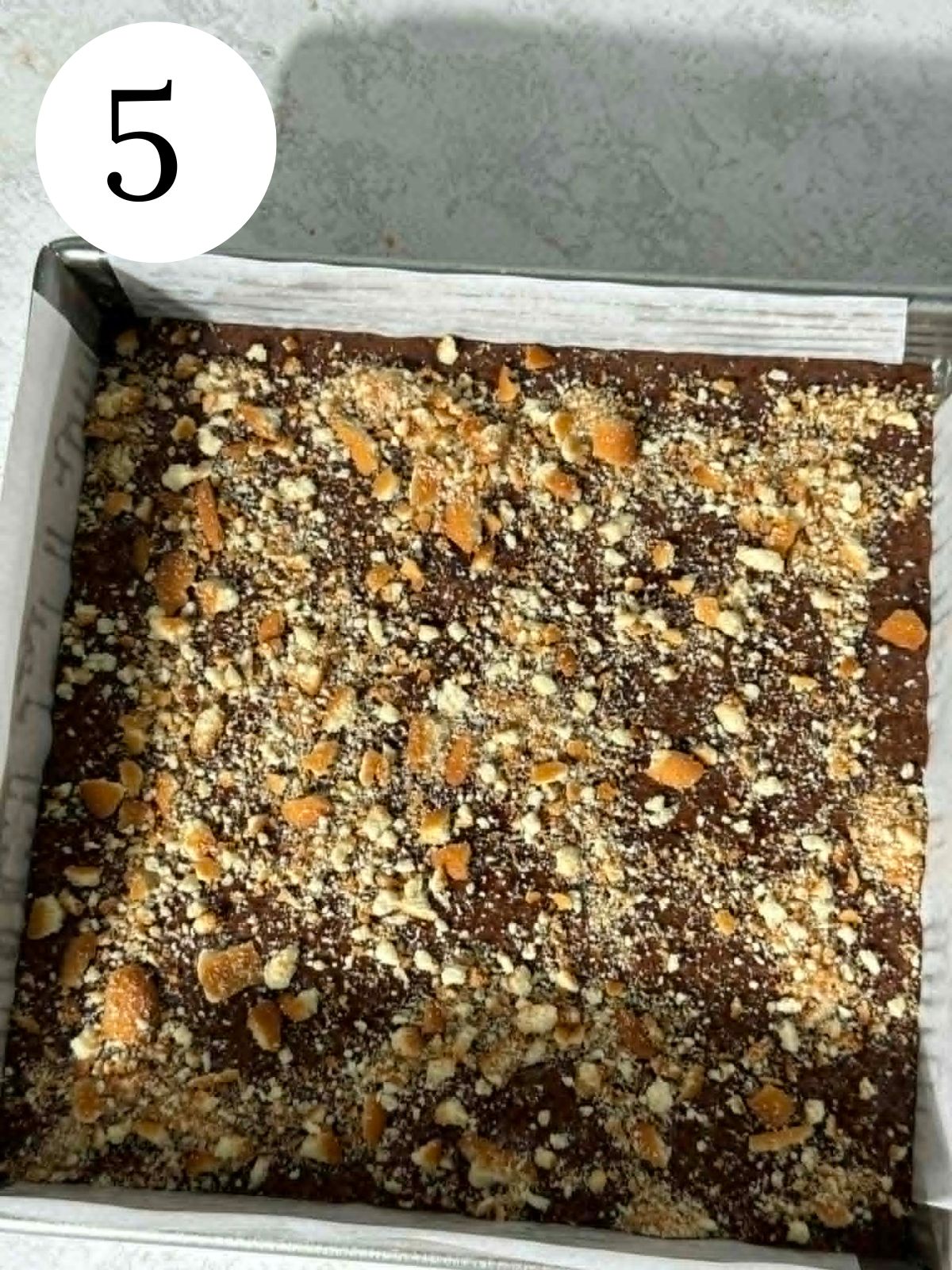 Chocolate brownies topped with Nilla wafers in a square pan.