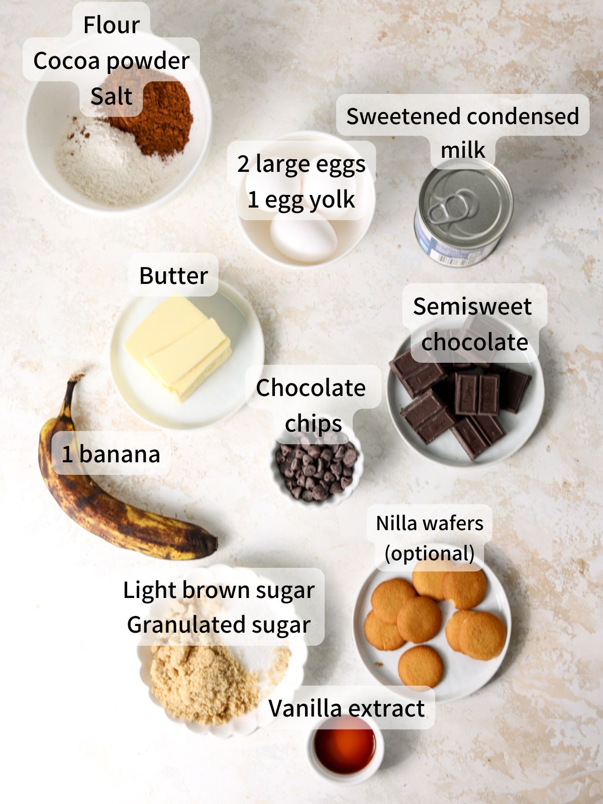 Labeled ingredients needed to make banana brownies laid out on a table. 