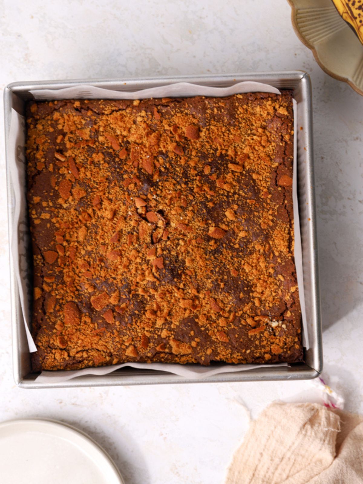 Banana brownies with crushed Nilla wafers in a pan. 