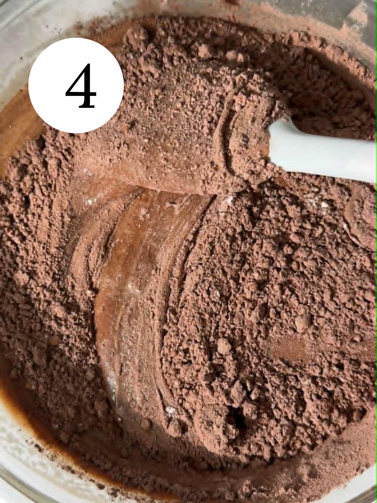 Folding cocoa powder into brownie batter. 