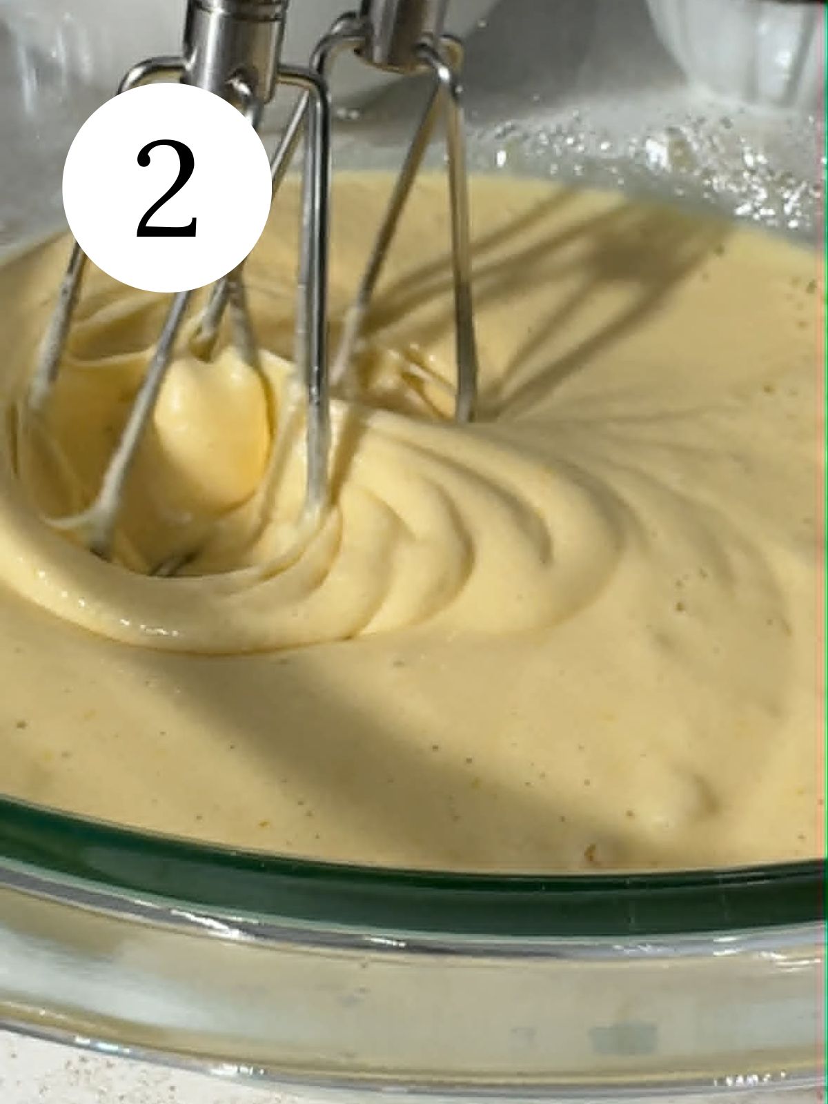 Beating eggs and sugar with an electric mixer. 