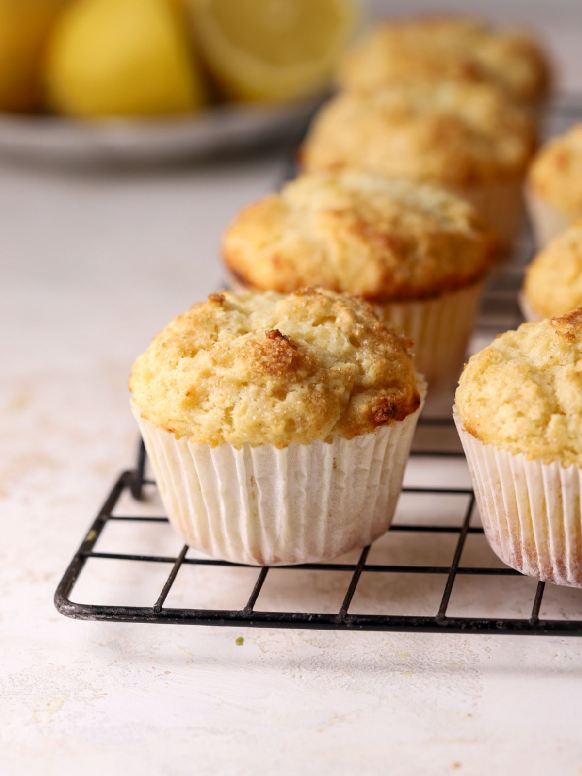 A batch of muffins on a wire cooling rack.
