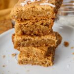 A stack of butterscotch bars cut into squares.