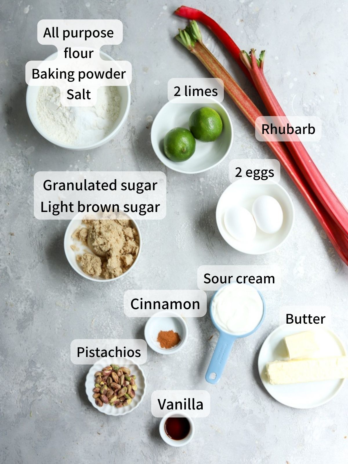 Labeled ingredients needed to make rhubarb cake laid out on a table.