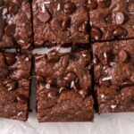 Chocolate cookie bars with chocolate chips sliced into squares.