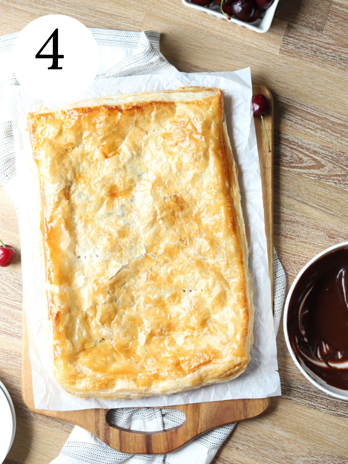 A golden brown slab pie on parchment paper.