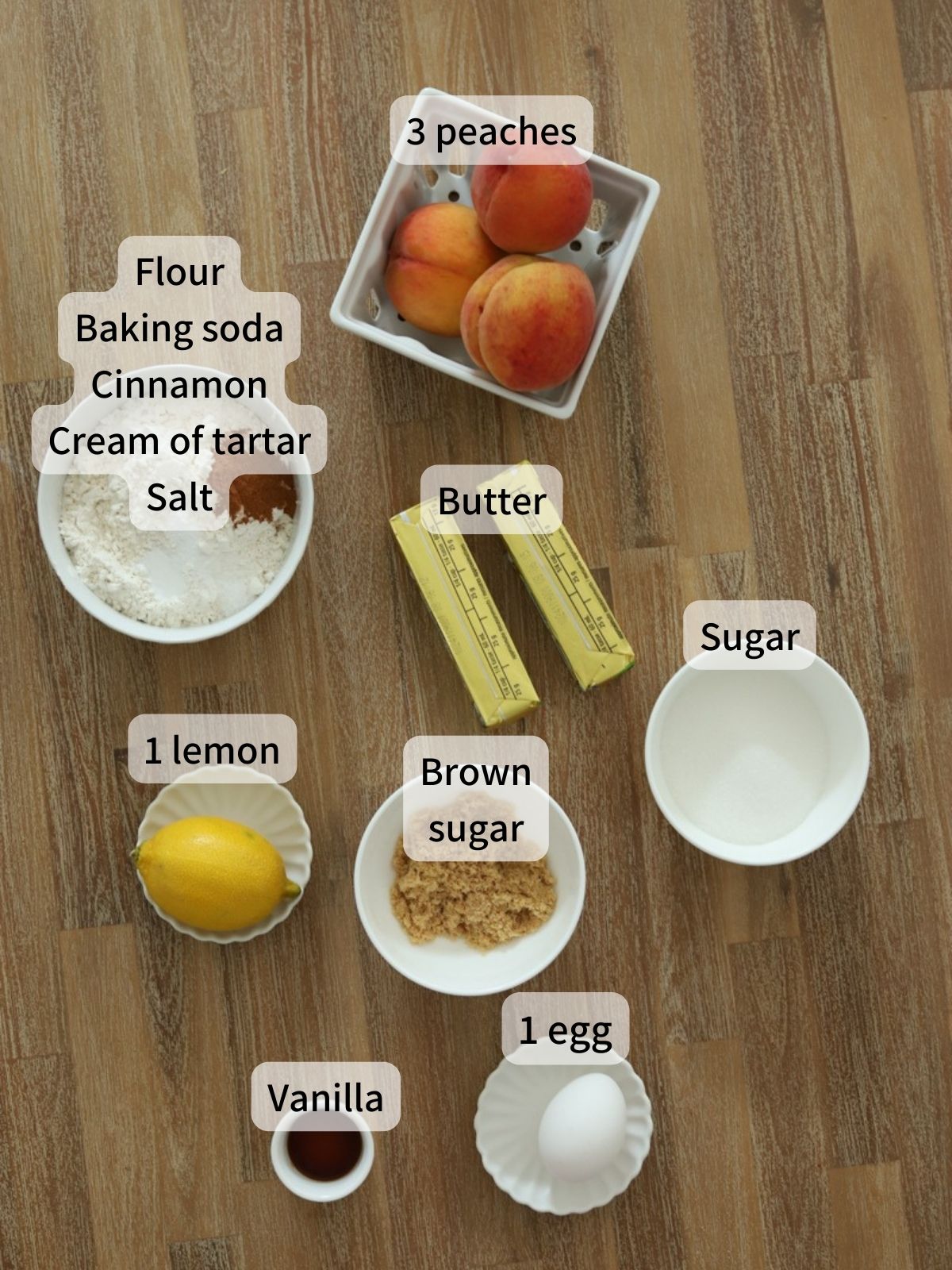Labeled ingredients needed to make peach cookies laid out on a table. 