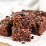 Pieces of chocolate focaccia stacked and topped with sea salt.